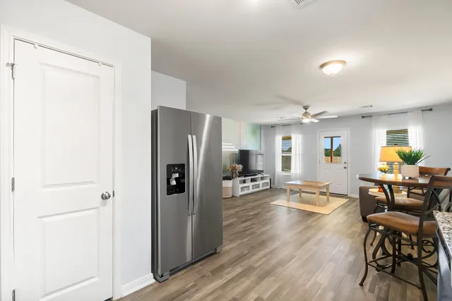 a kitchen with stainless steel appliances granite countertop a refrigerator stove and sink