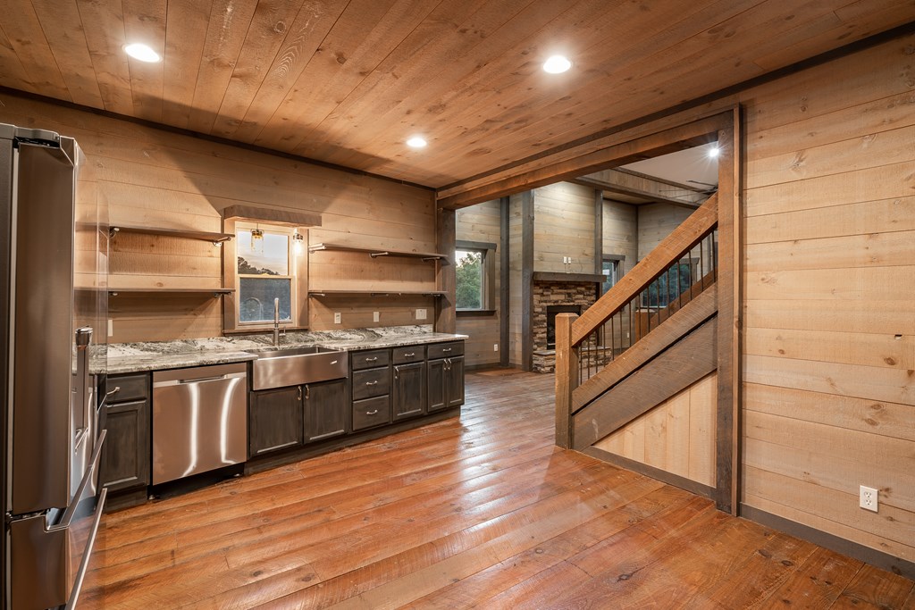 2637 River Road Mineral Bluff, GA 30559 - Photo 11 of 67 a kitchen with stainless steel appliances kitchen island granite countertop a stove a sink and a refrigerator