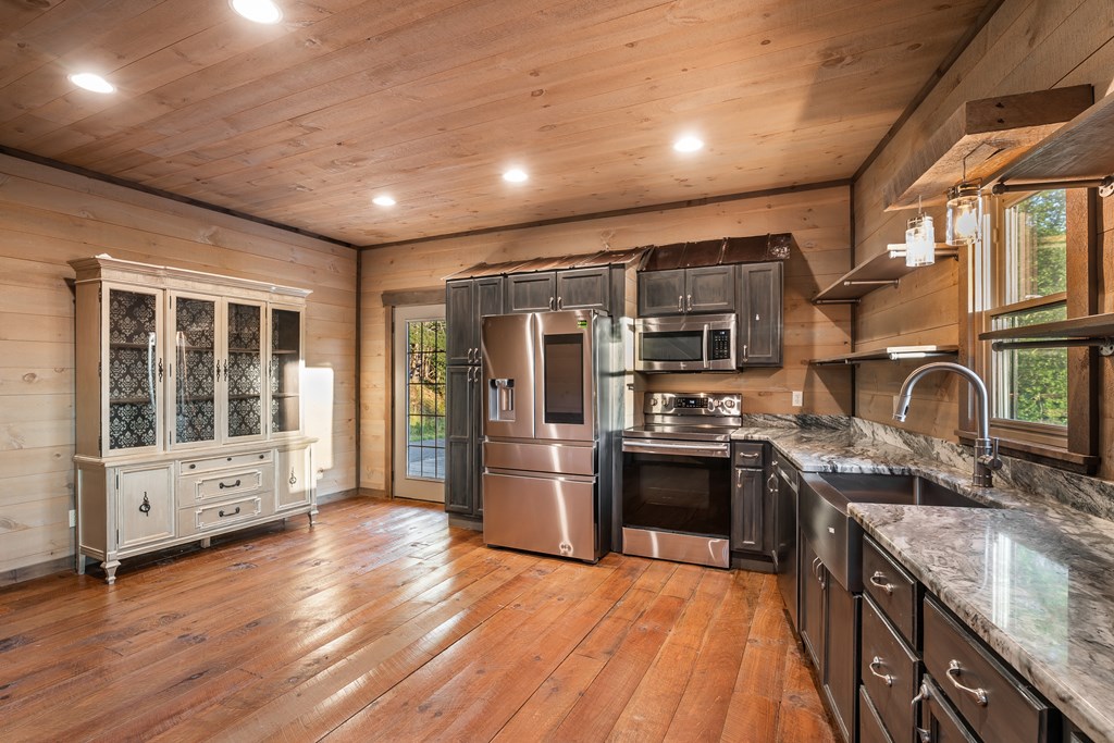 2637 River Road Mineral Bluff, GA 30559 - Photo 12 of 67 a kitchen with stainless steel appliances granite countertop a stove and a sink