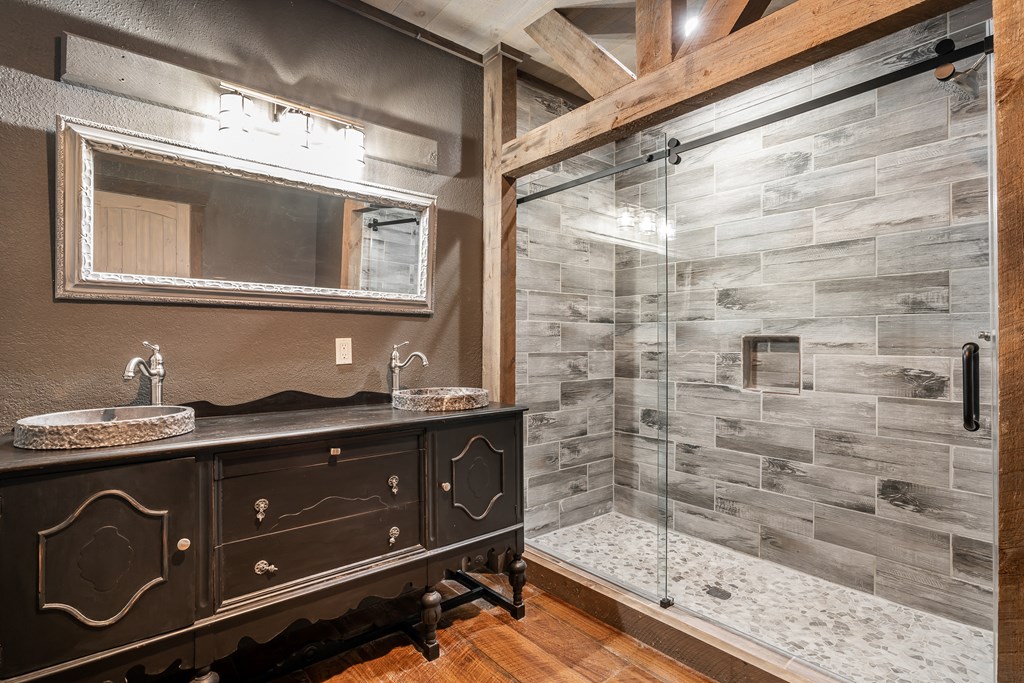 2637 River Road Mineral Bluff, GA 30559 - Photo 22 of 67 a bathroom with a sink a mirror and shower