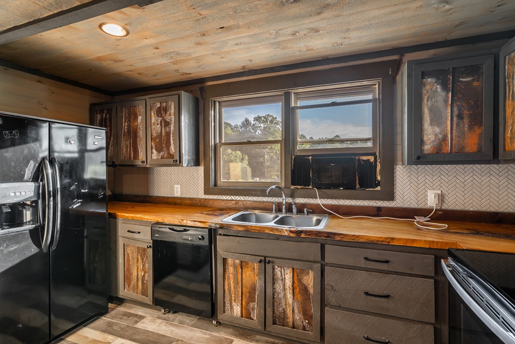 2637 River Road Mineral Bluff, GA 30559 - Photo 45 of 67 a kitchen with stainless steel appliances granite countertop a sink stove and refrigerator