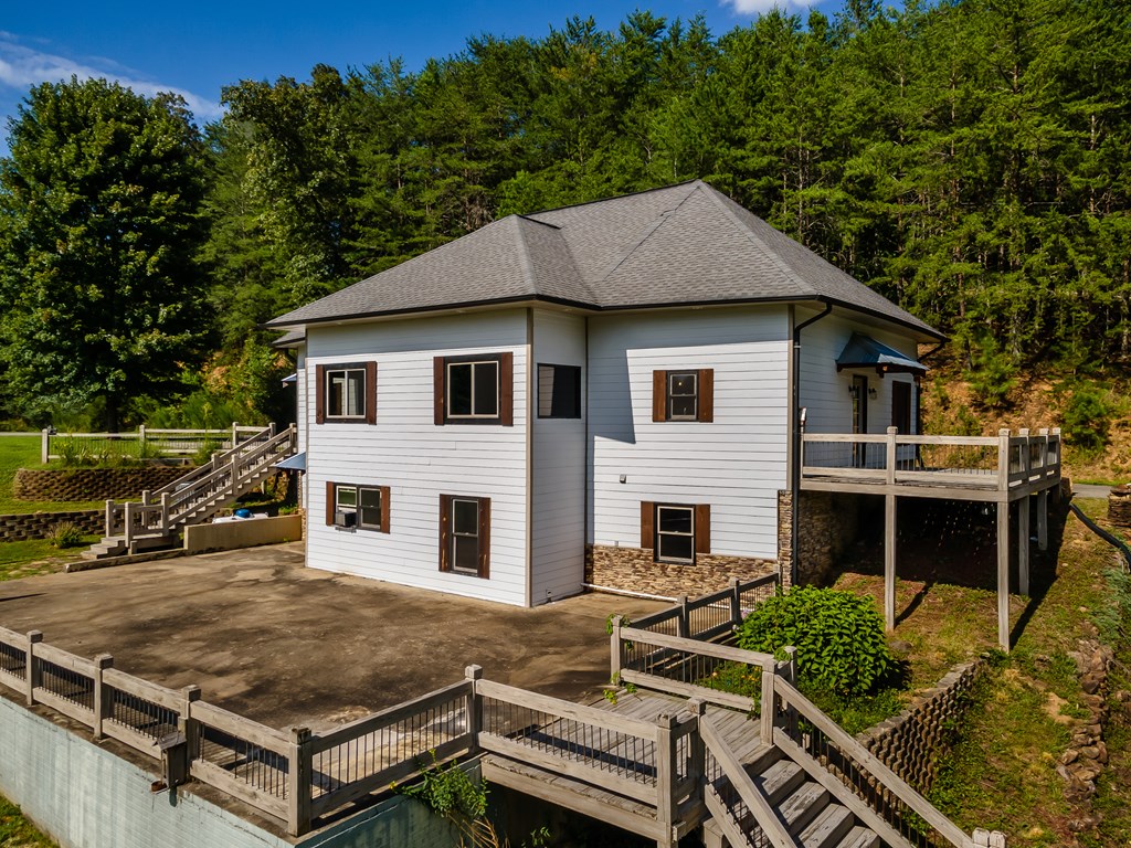2637 River Road Mineral Bluff, GA 30559 - Photo 60 of 67 a view of house with yard outdoor seating and covered with trees in the background