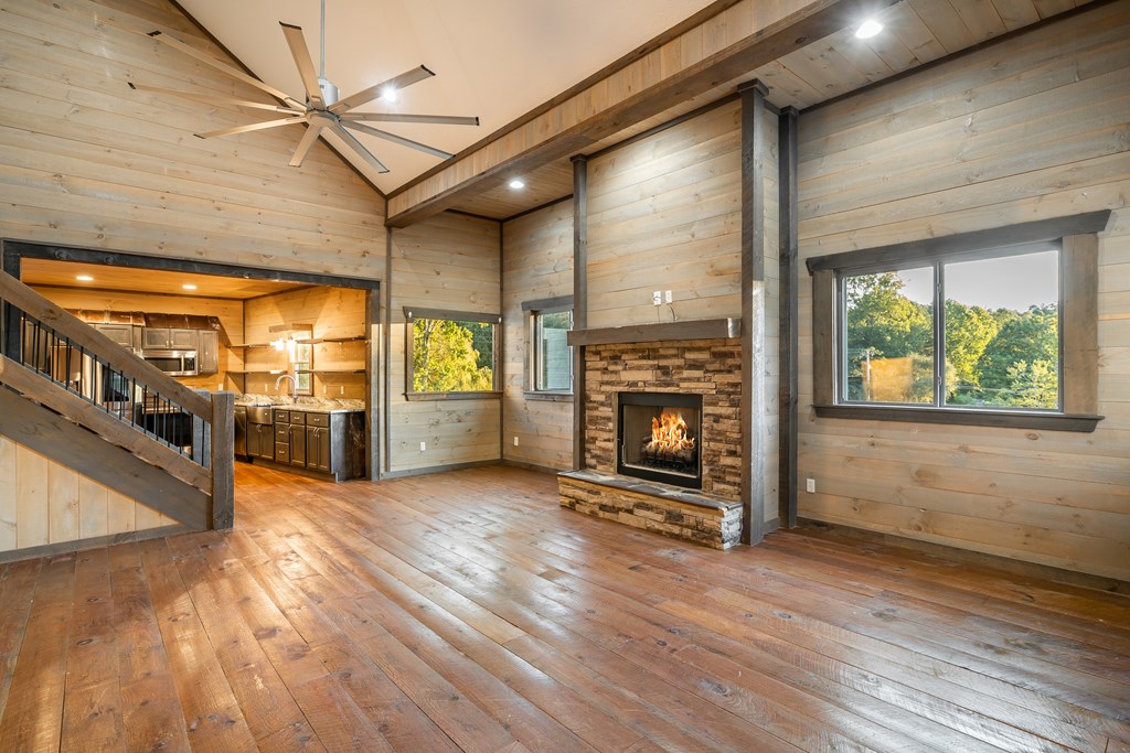 2637 River Road Mineral Bluff, GA 30559 - Photo 8 of 67 an empty room with wooden floor a fireplace and windows