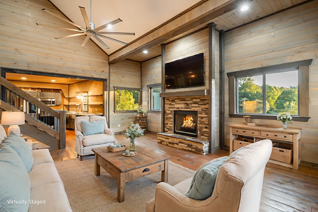 2637 River Road Mineral Bluff, GA 30559 - Photo 9 of 67 a living room with furniture a flat screen tv and a fireplace