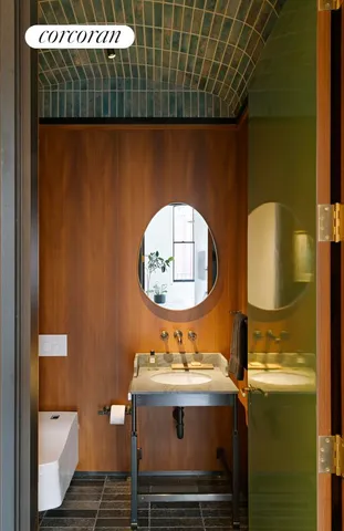 a bathroom with a sink mirror vanity and toilet
