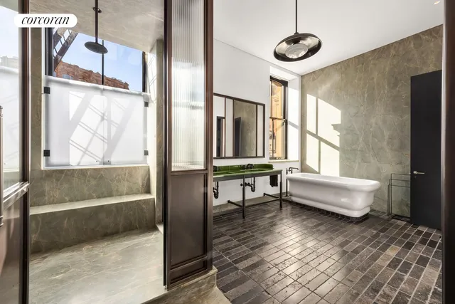 a bathroom with a bathtub and a shower