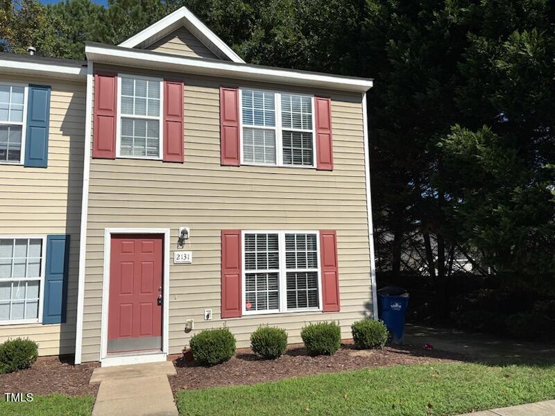 2131 Walnut Bluffs Lane Raleigh, NC 27610 - Photo 1 of 9 a front view of a house with garden
