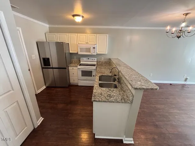 a kitchen with a refrigerator sink and stove
