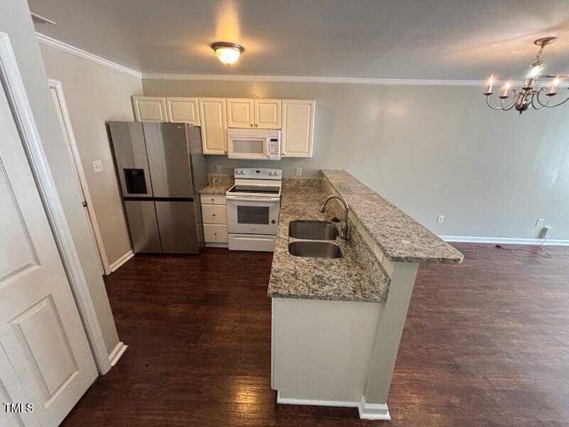 2131 Walnut Bluffs Lane Raleigh, NC 27610 - Photo 4 of 9 a kitchen with a refrigerator sink and stove