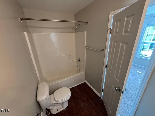 a bathroom with a shower and toilet