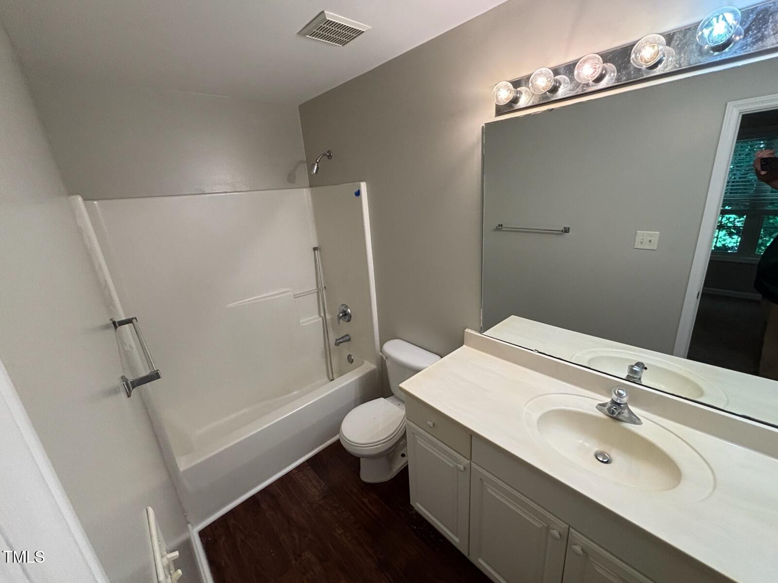 2131 Walnut Bluffs Lane Raleigh, NC 27610 - Photo 9 of 9 a bathroom with a sink a toilet a mirror and shower