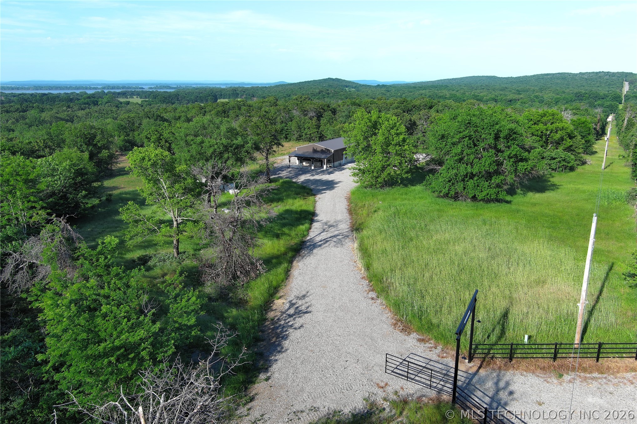 20862 East 1160th Road Keota, OK 74941 - Photo 17 of 47 Gravel driveway accessing a contemporary home with a dark-toned exterior