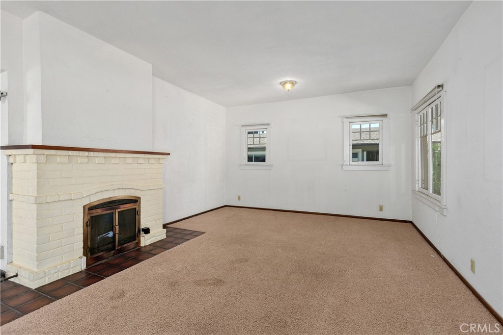 3892 Oakwood Place Riverside, CA 92506 - Photo 5 of 36 Light-filled interior space showcasing the home's original windows and open space. There is oak hardwood under the carpet.