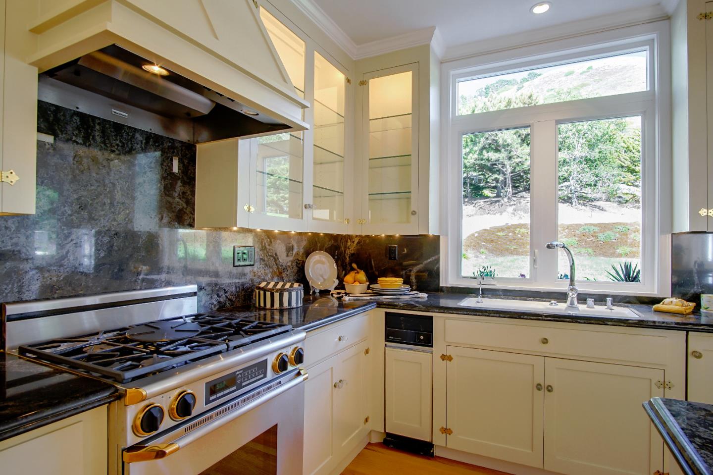 21 Mentone Road Carmel, CA 93923 - Photo 22 of 80 a kitchen with a stove a sink and a granite counter tops