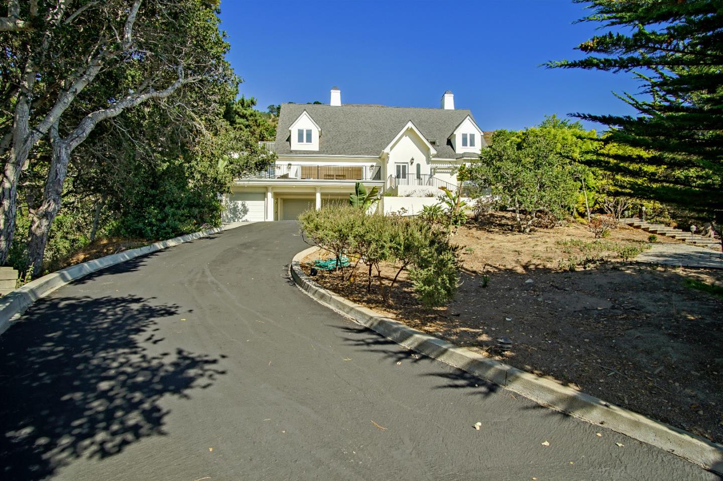 21 Mentone Road Carmel, CA 93923 - Photo 4 of 80 a front view of a house with a yard