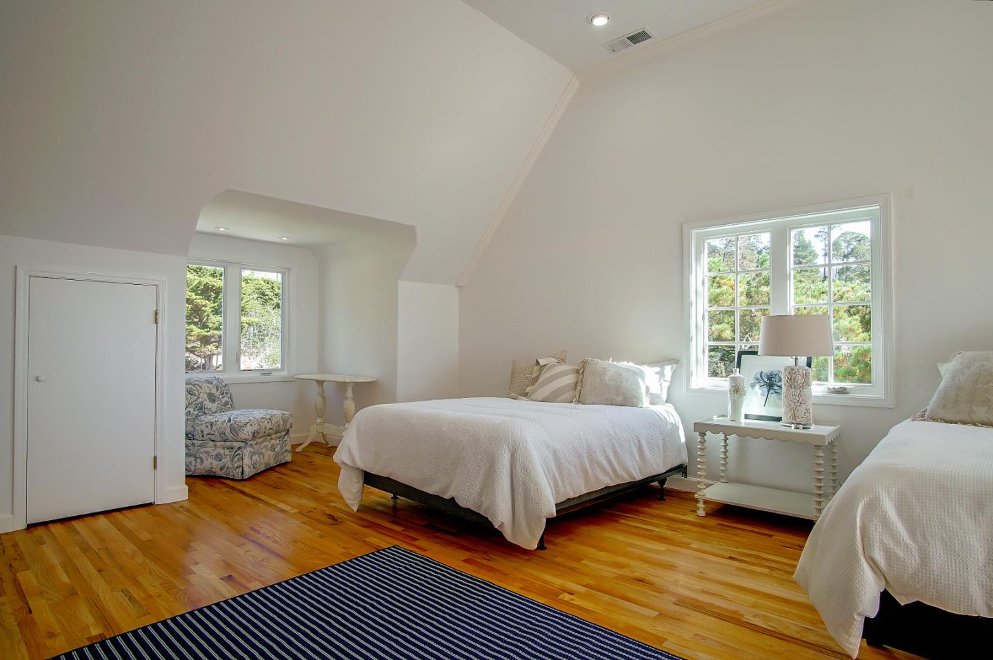 21 Mentone Road Carmel, CA 93923 - Photo 44 of 80 a bedroom with a bed and wooden floor