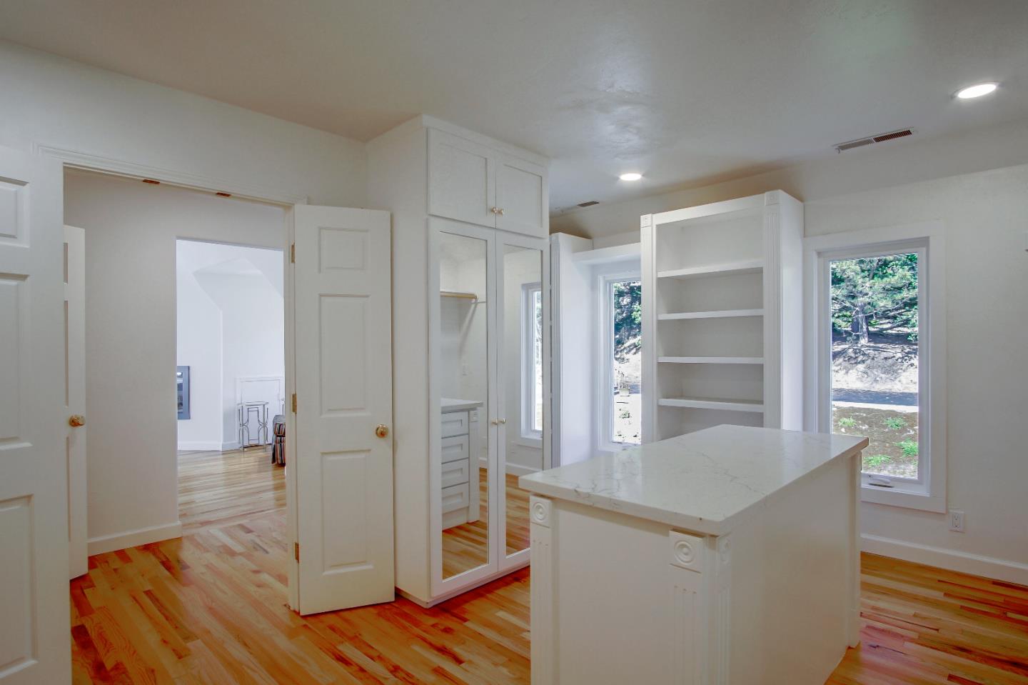 21 Mentone Road Carmel, CA 93923 - Photo 54 of 80 a view of a hallway with wooden floor and staircase
