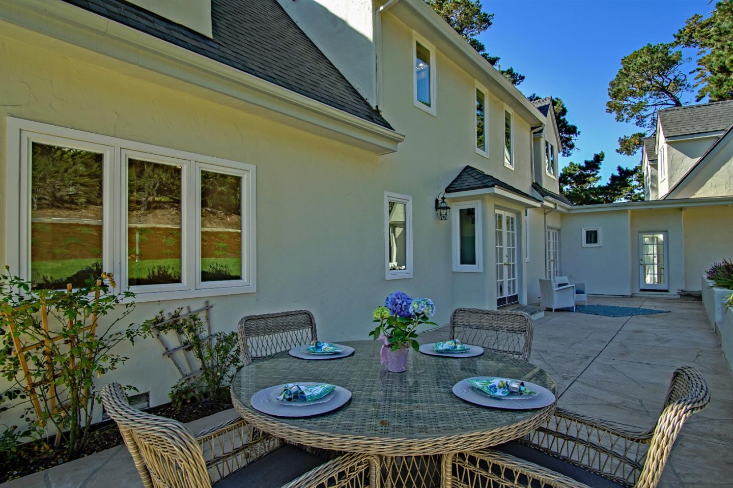 21 Mentone Road Carmel, CA 93923 - Photo 66 of 80 a view of a patio with couches table and chairs and potted plants