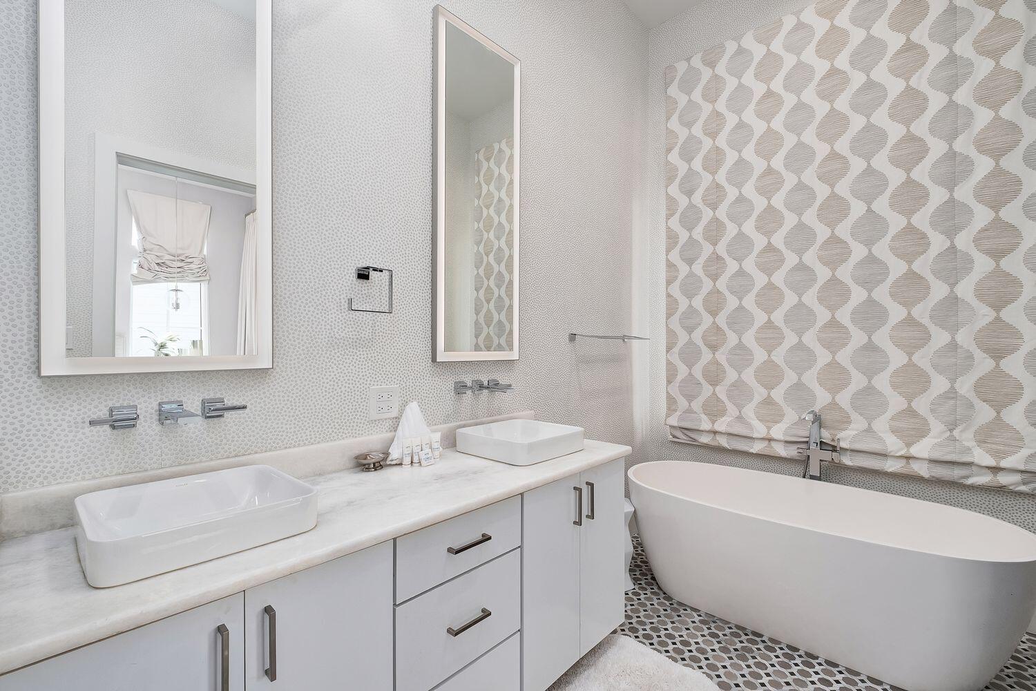 2657 East County Highway 30A Santa Rosa Beach, FL 32459 - Photo 16 of 59 a bathroom with a bathtub sink vanity mirror and a