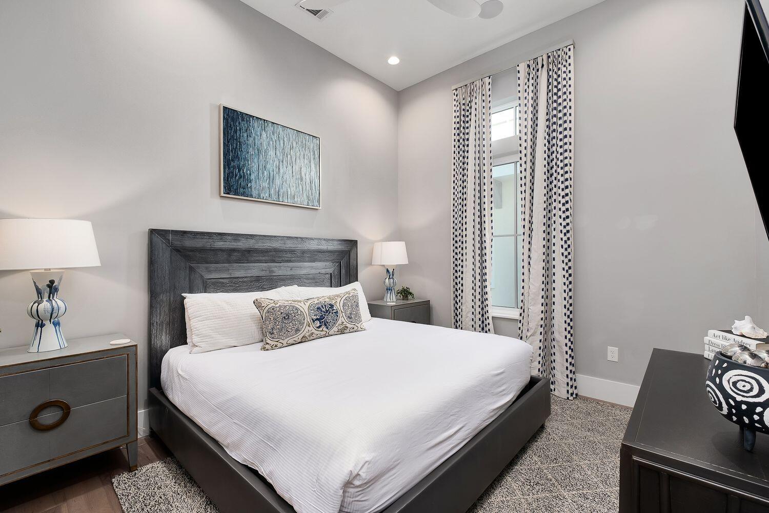 2657 East County Highway 30A Santa Rosa Beach, FL 32459 - Photo 23 of 59 a bedroom with a bed and a night stand