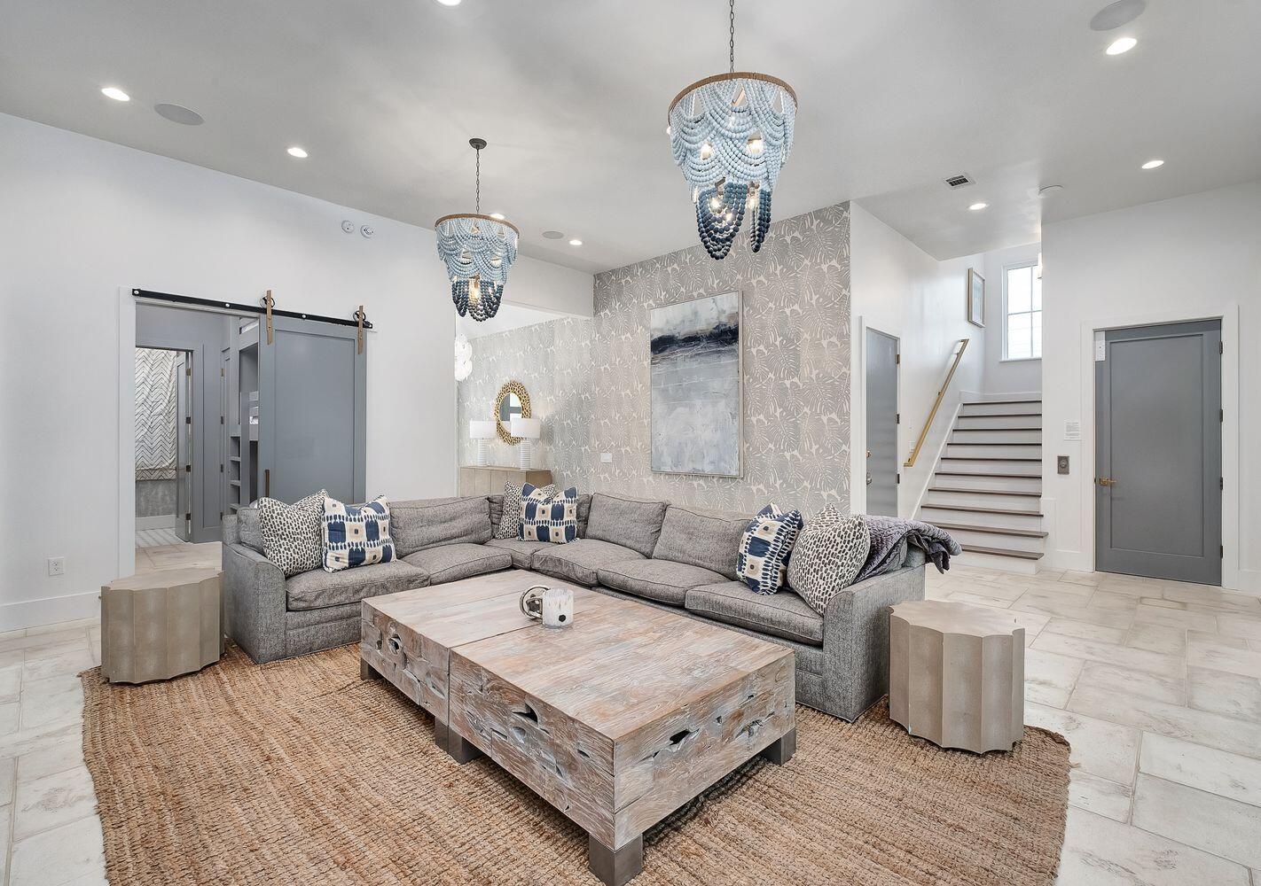 2657 East County Highway 30A Santa Rosa Beach, FL 32459 - Photo 37 of 59 a spacious bedroom with a bed and a chandelier