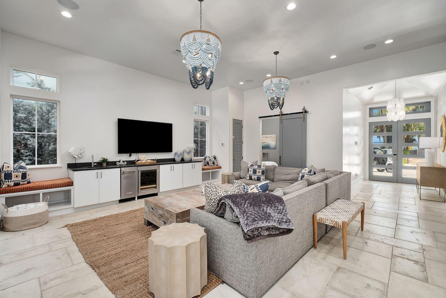2657 East County Highway 30A Santa Rosa Beach, FL 32459 - Photo 39 of 59 a living room with furniture a flat screen tv and kitchen view