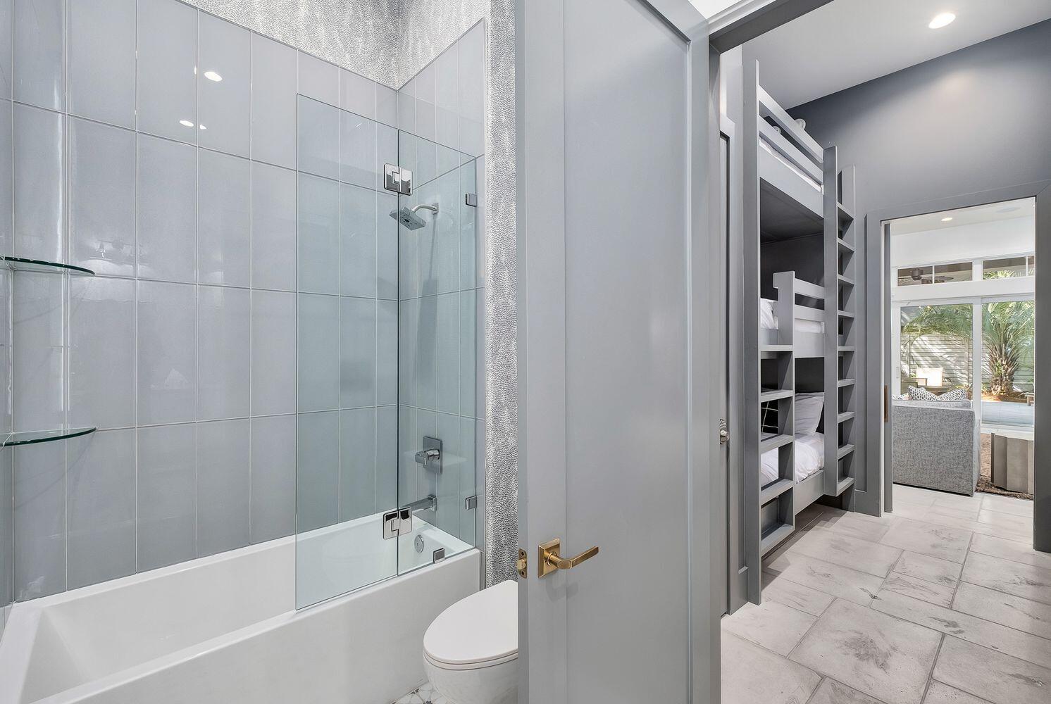 2657 East County Highway 30A Santa Rosa Beach, FL 32459 - Photo 43 of 59 a bathroom with a bathtub a toilet and a shower