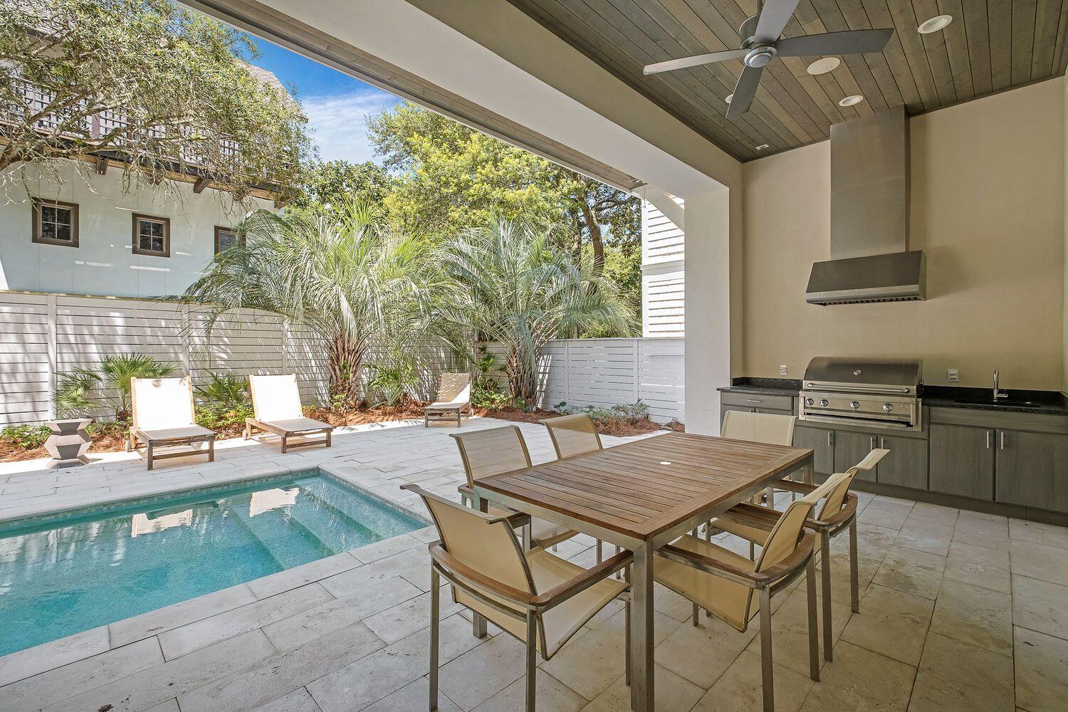 2657 East County Highway 30A Santa Rosa Beach, FL 32459 - Photo 52 of 59 a view of a dining table and chairs in the patio