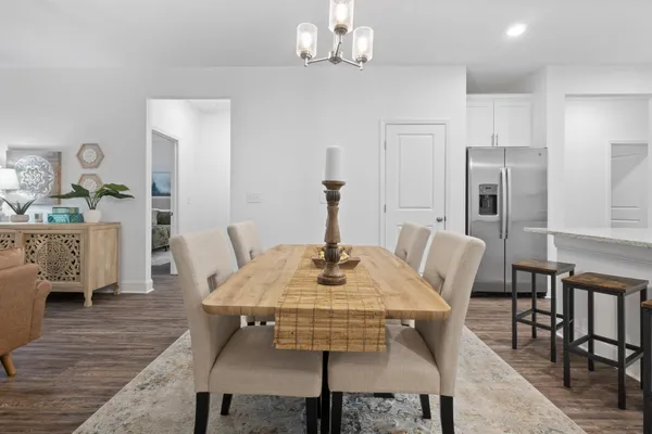 a view of a dining room with furniture and wooden floor