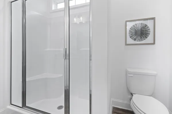 a white toilet sitting next to a bathroom sink