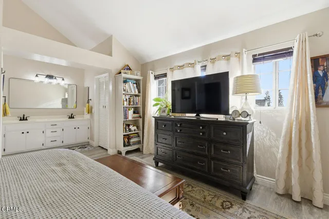 a room with a television and dresser