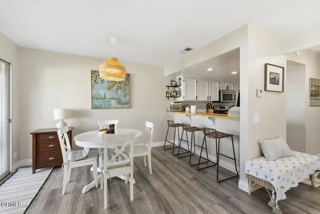 a dining room with furniture and a wooden floor