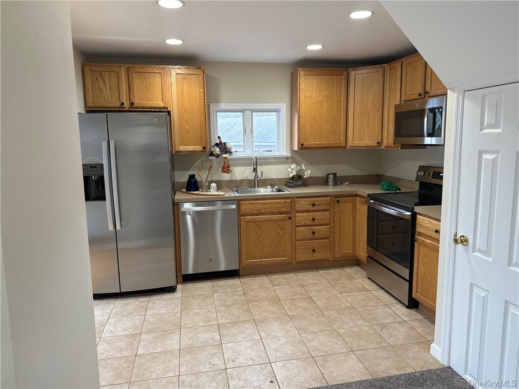 100 Dunderberg Road Putnam Valley, NY 10579 - Photo 4 of 29 a kitchen with stainless steel appliances granite countertop a stove a sink and a refrigerator