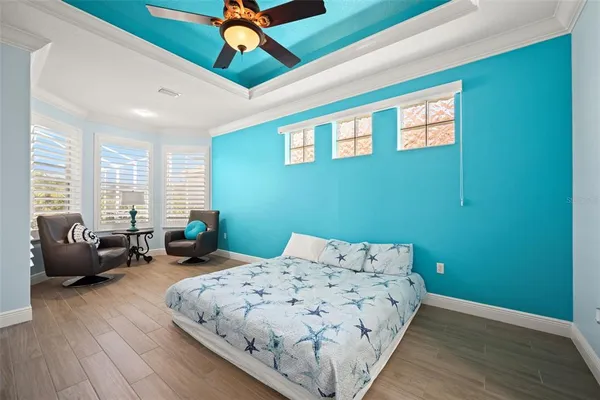 a view of a swimming pool with chairs and tables