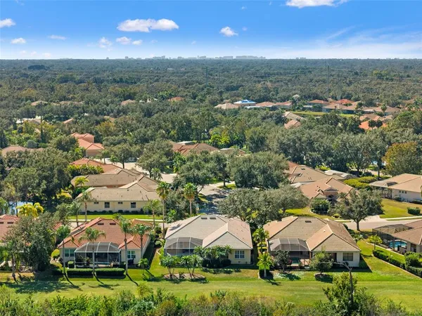 an aerial view of residential houses with outdoor space and swimming pool