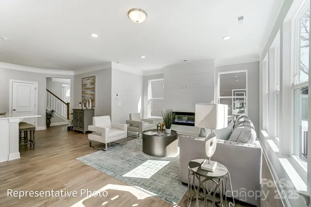 a living room with furniture a fireplace and a table