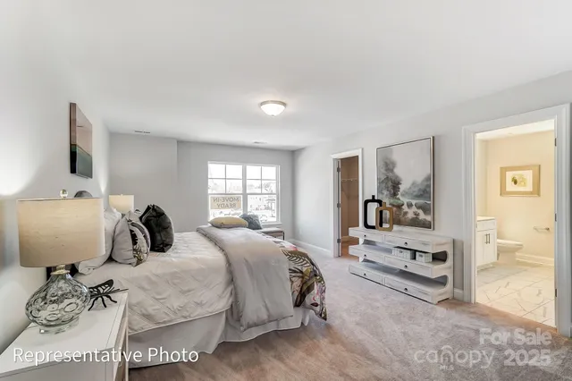 a bedroom with a bed a mirror and desk