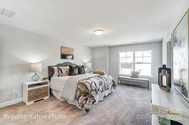 a spacious bedroom with a bed a couch and a window