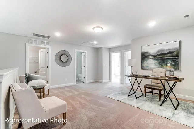 a living room with furniture and a clock
