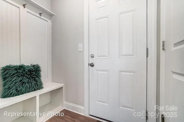 a room with a chair and potted plant