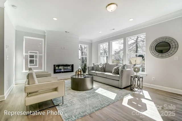 a living room with furniture a fireplace and a table