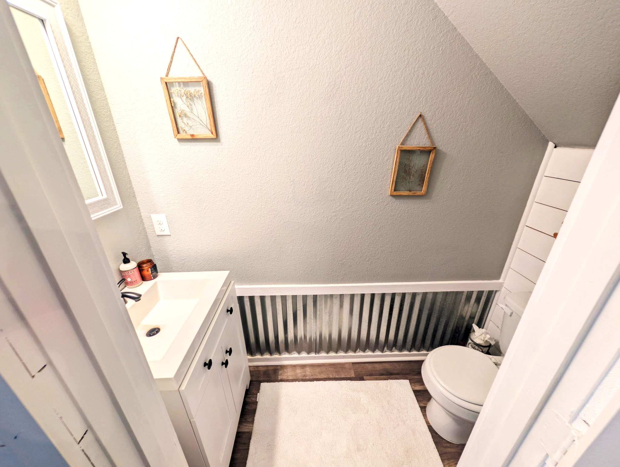 100 Wincliff Cove, Unit 13D Jarrell, TX 76537 - Photo 7 of 21 Half bath featuring a white vanity with a rectangular basin sink, wood-finish flooring.