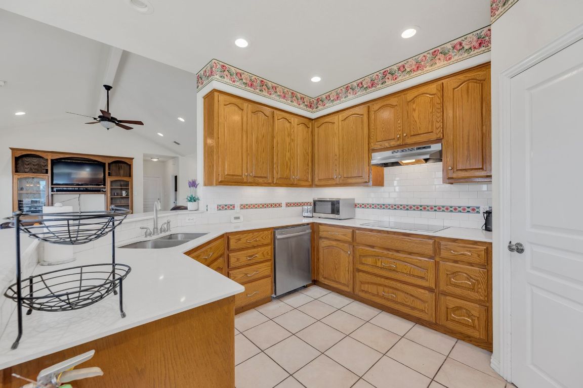 1949 Farm To Market Road 619 Elgin, TX 78621 - Photo 10 of 36 a kitchen with stainless steel appliances granite countertop sink and cabinets