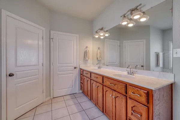 a bathroom with double sink and a mirror