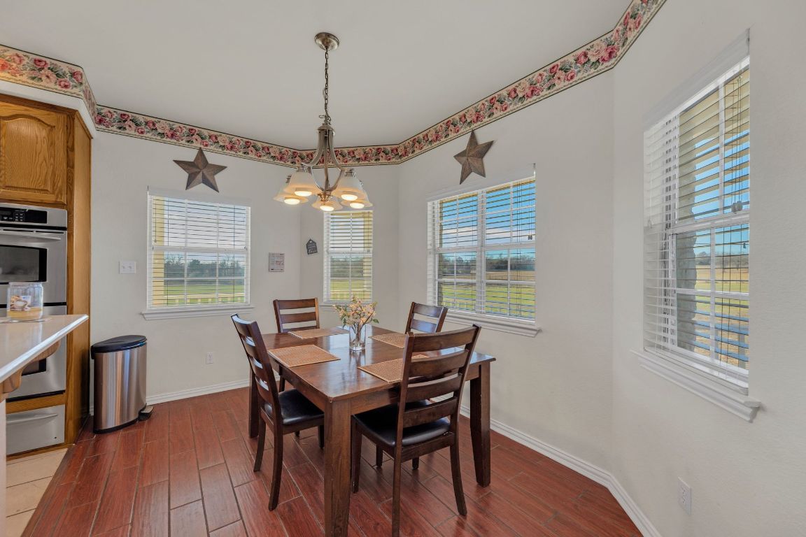 1949 Farm To Market Road 619 Elgin, TX 78621 - Photo 13 of 36 a view of a dining room with furniture window and wooden floor