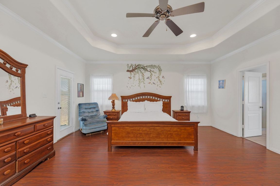 1949 Farm To Market Road 619 Elgin, TX 78621 - Photo 14 of 36 a bedroom with a bed and wooden floor