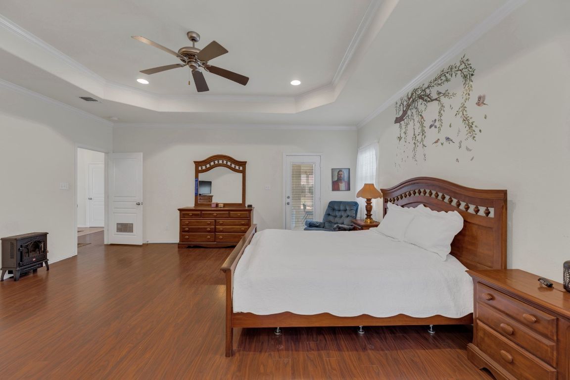 1949 Farm To Market Road 619 Elgin, TX 78621 - Photo 16 of 36 a bedroom with bed and wooden floor
