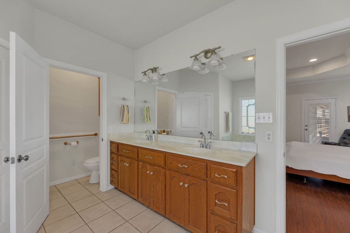 1949 Farm To Market Road 619 Elgin, TX 78621 - Photo 18 of 36 a spacious bathroom with a granite countertop sink a mirror and shower