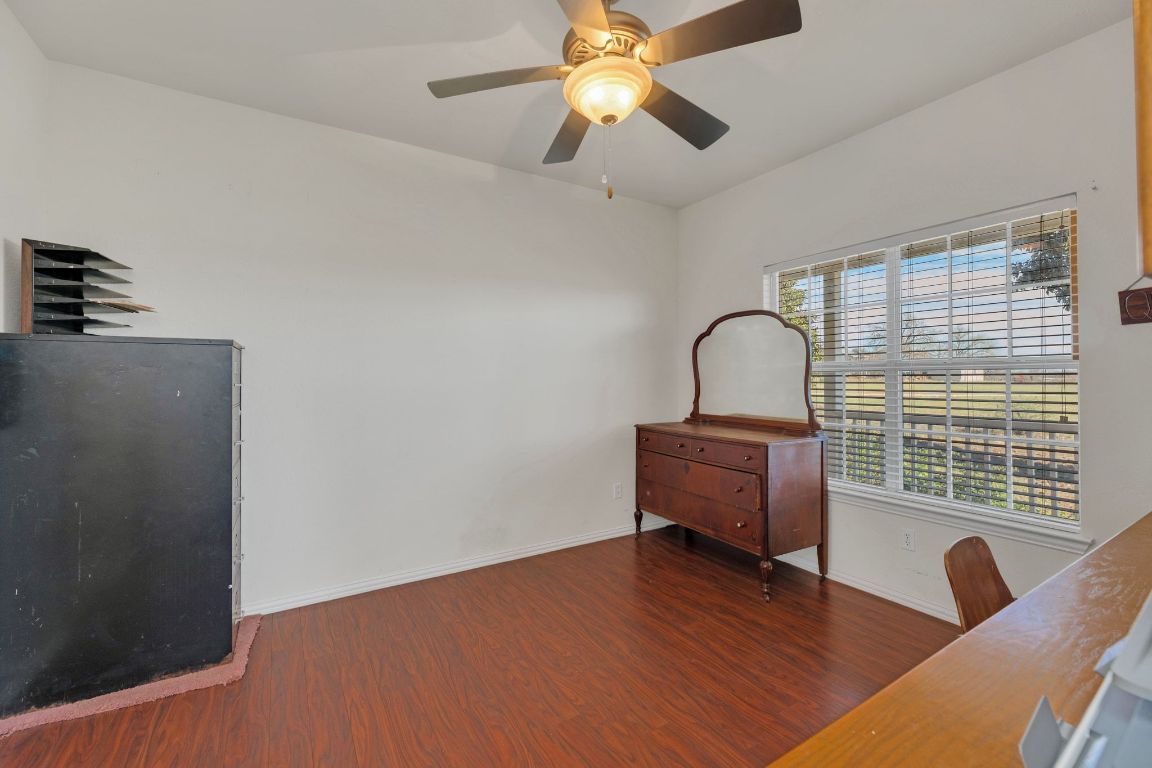 1949 Farm To Market Road 619 Elgin, TX 78621 - Photo 19 of 36 a bedroom with furniture and wooden floor