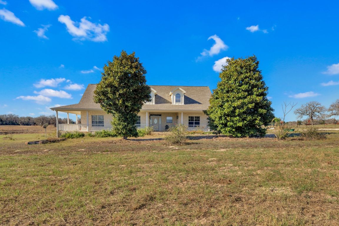 1949 Farm To Market Road 619 Elgin, TX 78621 - Photo 2 of 36 View of front of house with a large porch and a front lawn